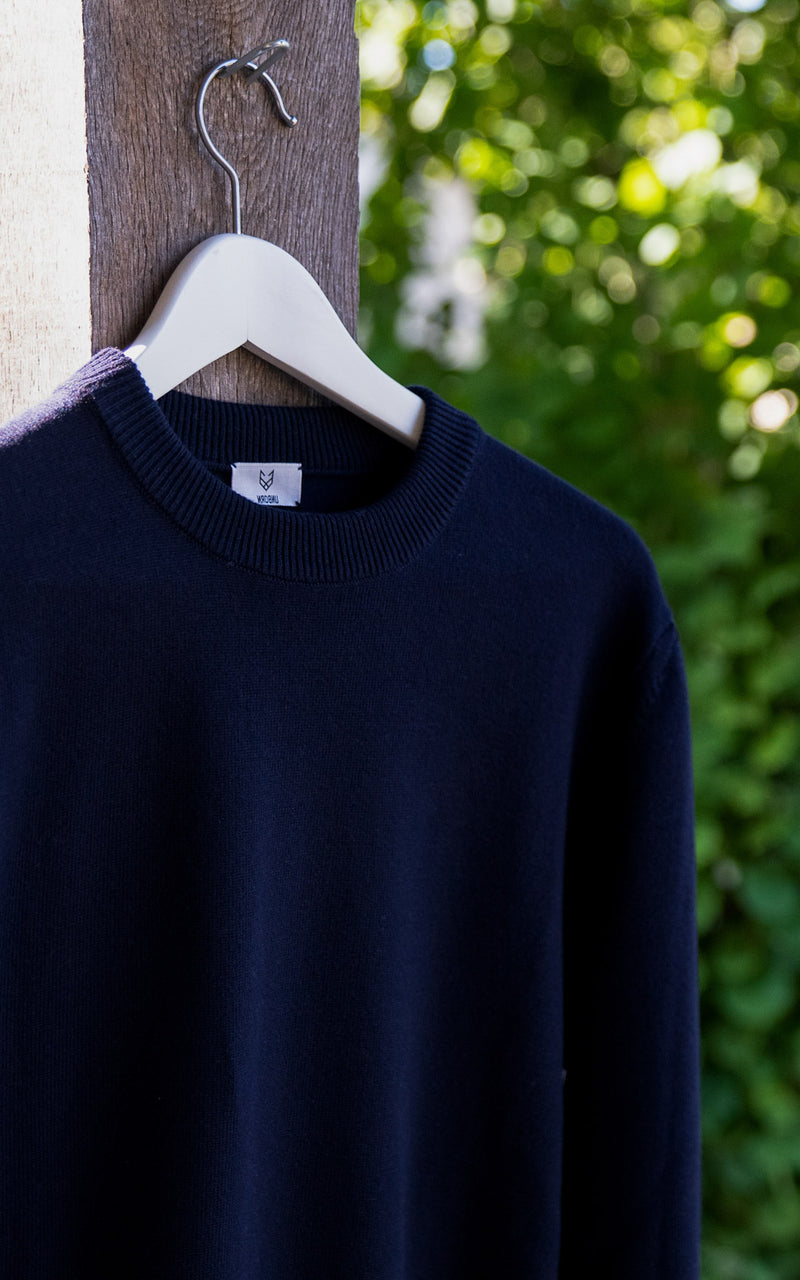 The Merino sweater from unborn airing out on a hanger in garden