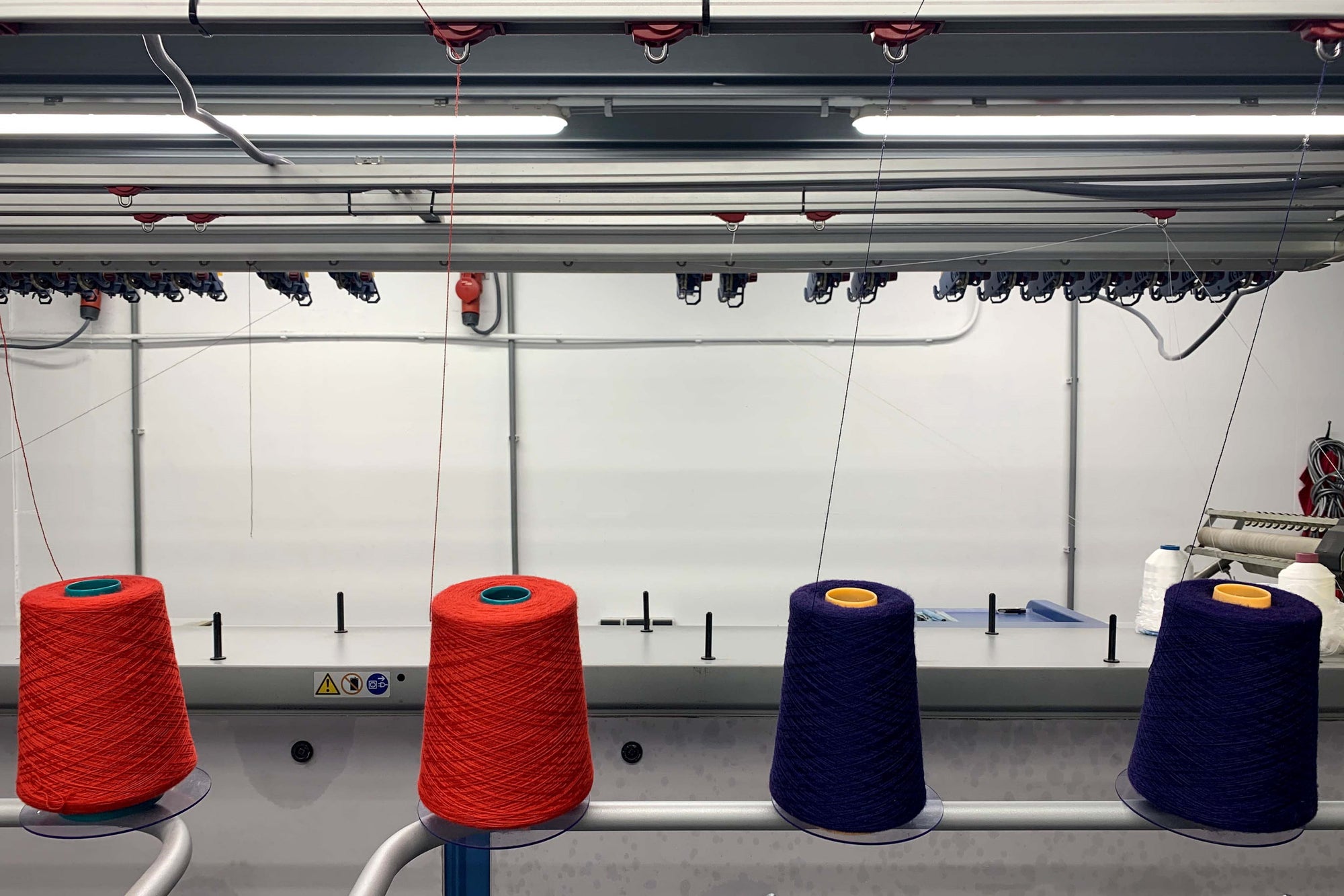 An industrial Stoll knitting machine at Knitwealab with cradle to cradle certified Arkaba Merino wool yarns