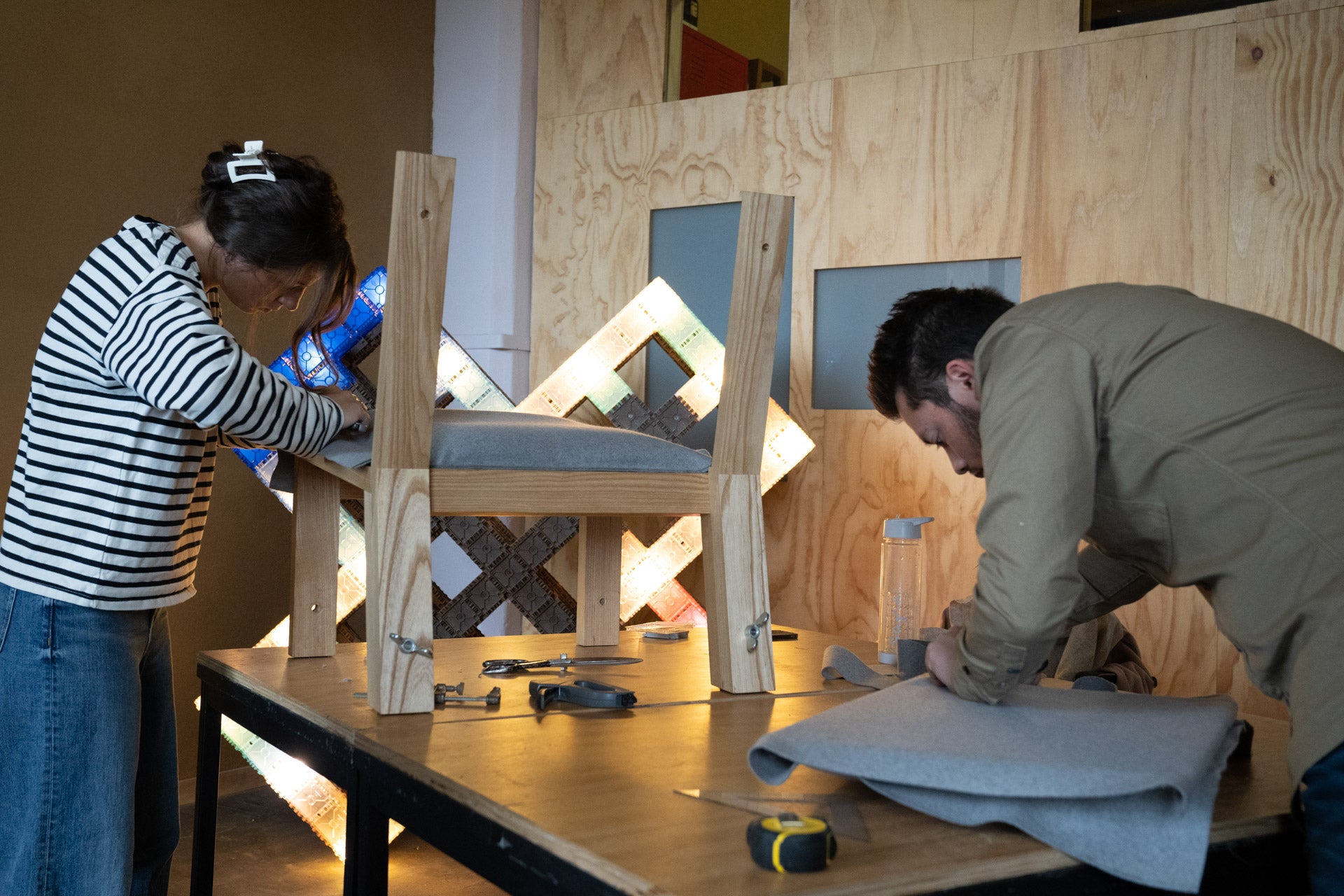 Interns at Melle Koot working on the assembly of the Herbarium lounge chair