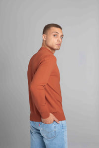 Model wearing The Merino Sweater lightweight Burnt Orange, right view - Unborn