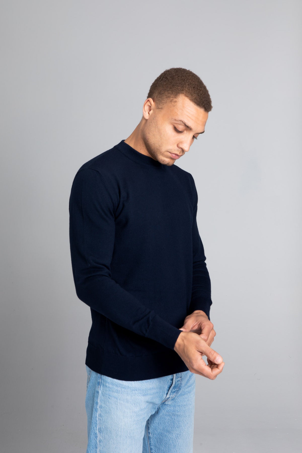 Model wearing The Merino Sweater lightweight Navy, front view - Unborn