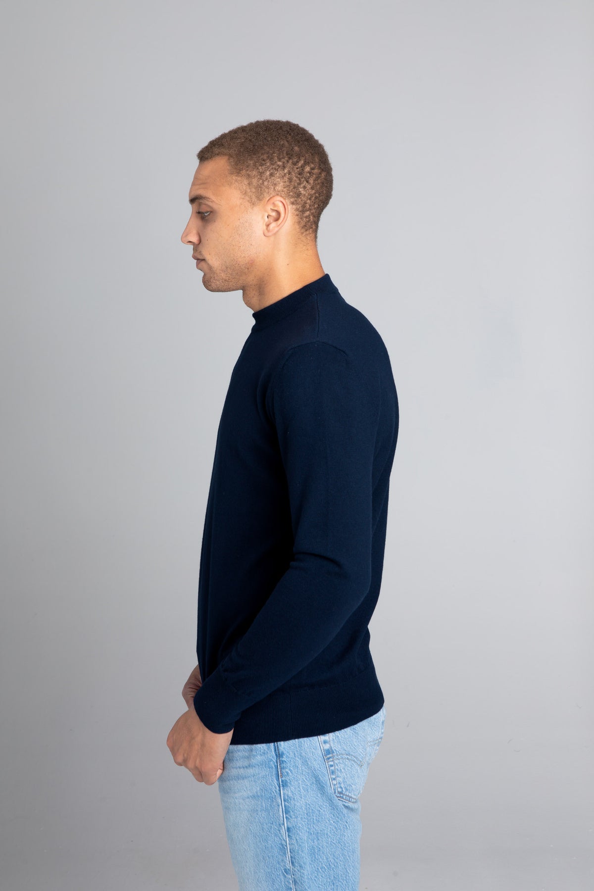 Model wearing The Merino Sweater lightweight Navy, left view - Unborn