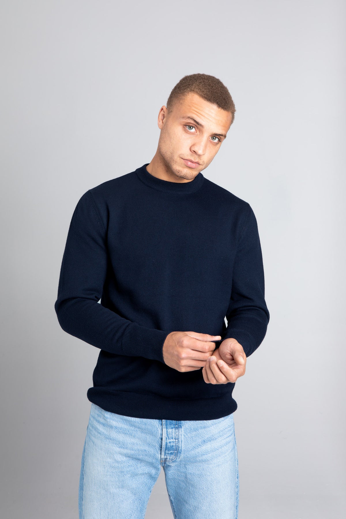 Model wearing The Merino sweater Navy, front view - Unborn
