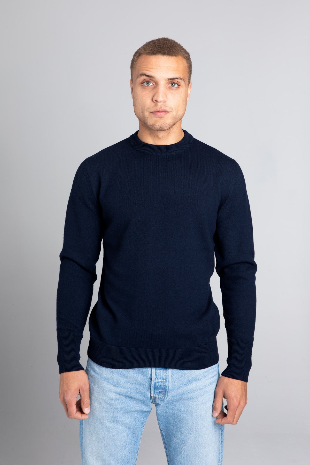 Model wearing The Merino sweater Navy, front view - Unborn