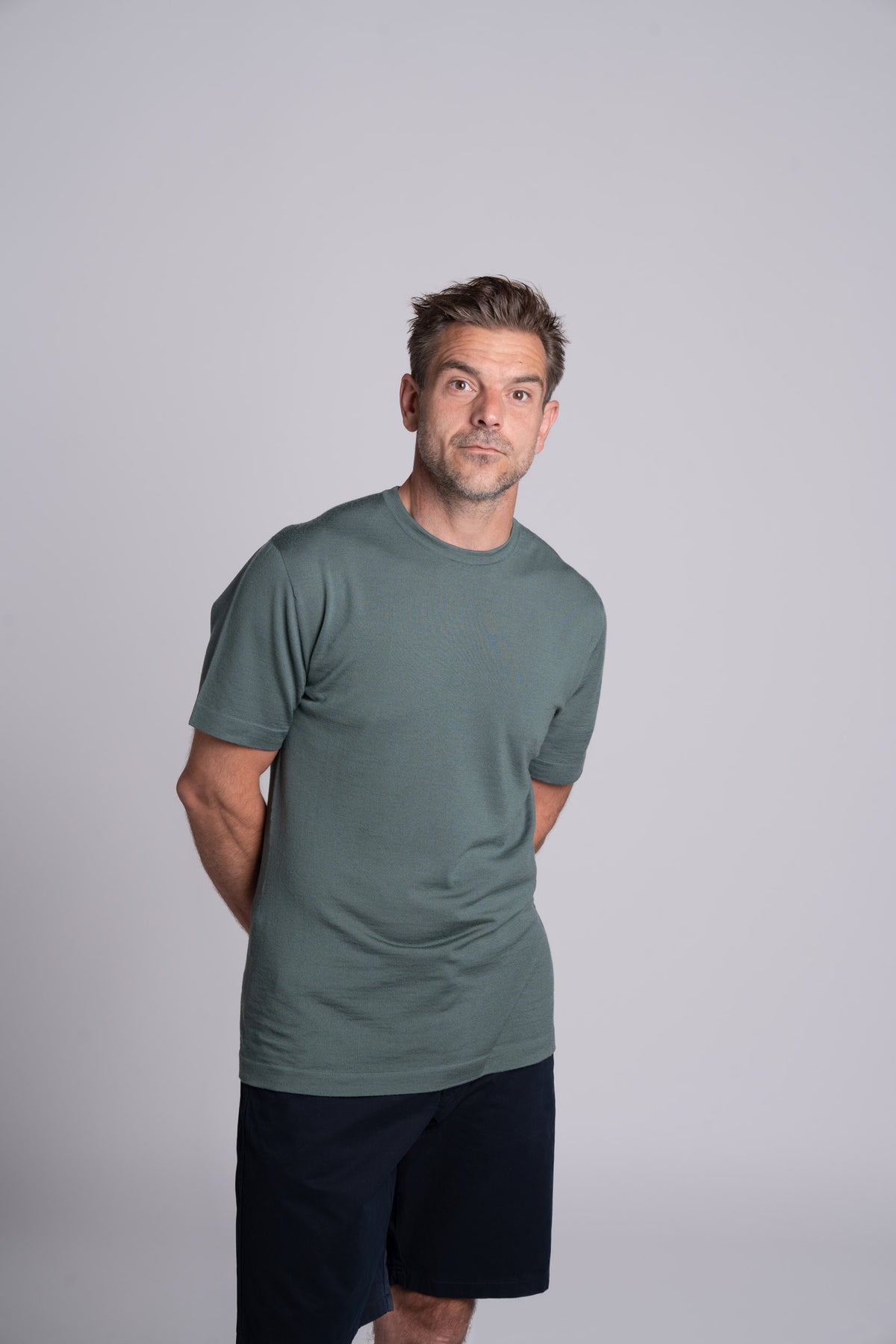 Model wearing Merino Featherweight T-shirt Moss Green Front View