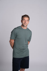 Model wearing Merino Featherweight T-shirt Moss Green Front View
