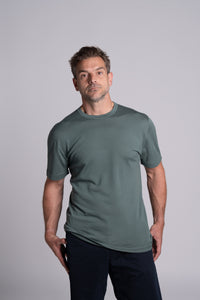Model wearing Merino Featherweight T-shirt Moss Green Front View