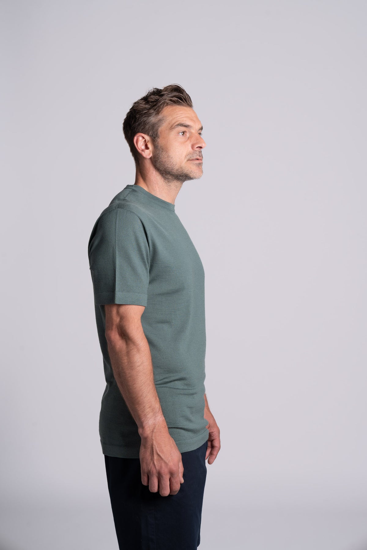 Model wearing Merino Featherweight T-shirt Moss Green Side View