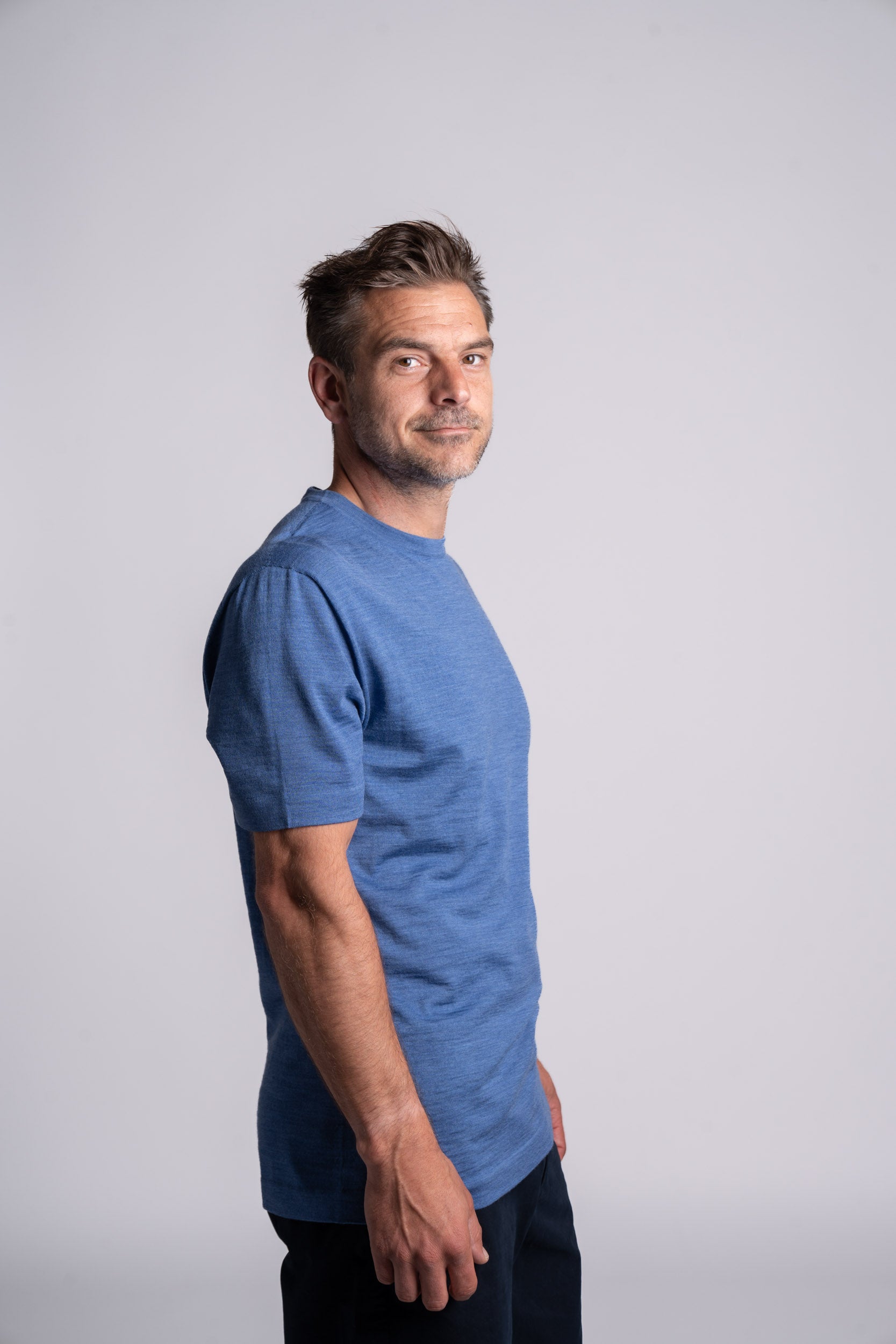 Model wearing Merino Featherweight T-shirt Sky Blue Side View