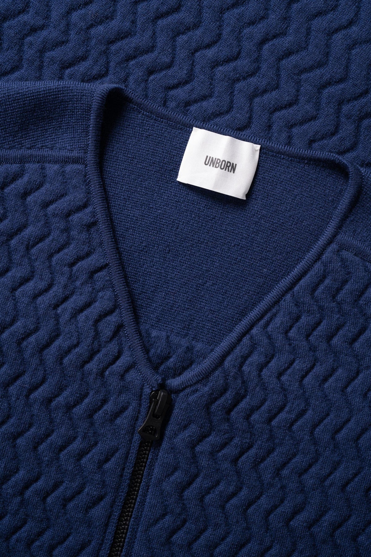 Close up with details of the collar of the UNBORN Merino d'Arles Padded vest in medieval blue