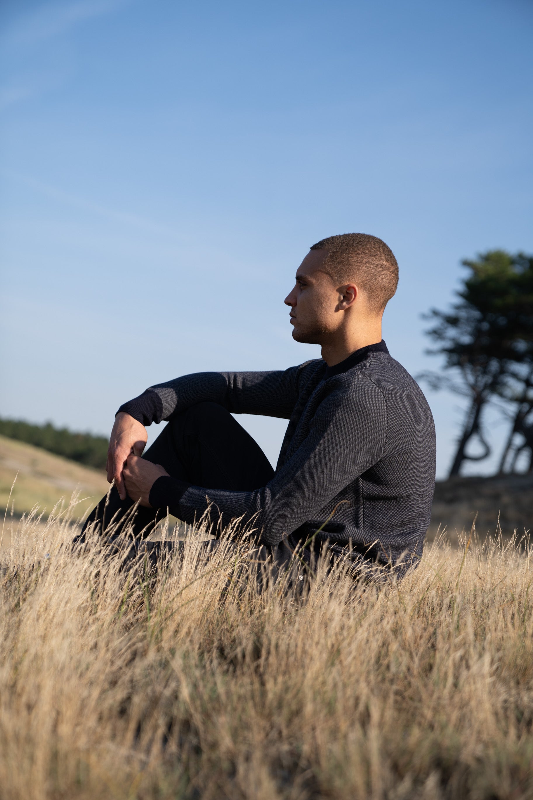 Model Wearing Heavy Merino Sweater Sitting Dunes 