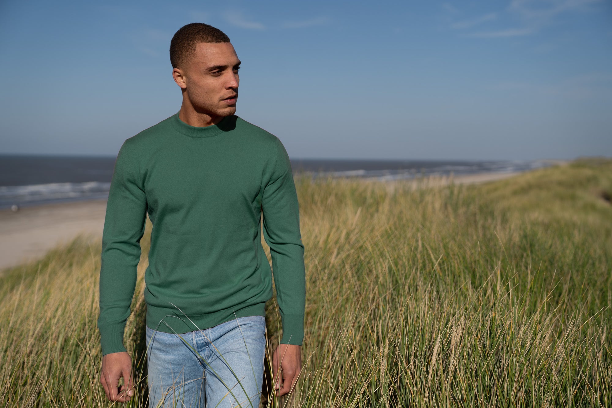 Model Wearing Light Merino Sweater Foggy Green Beach