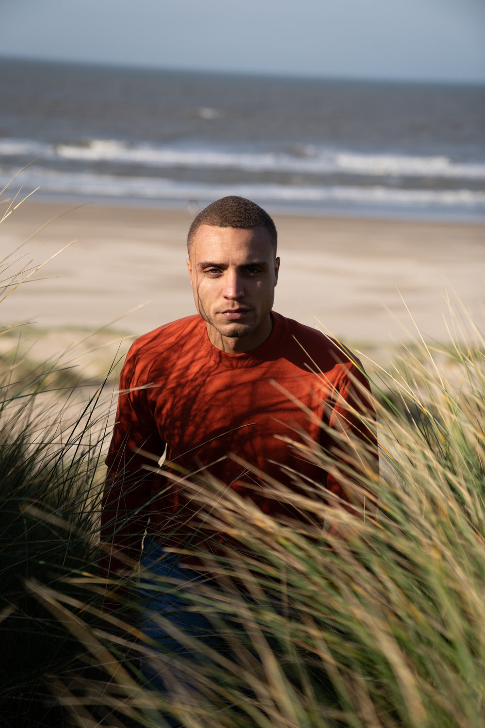Model Wearing Light Merino Sweater Orange Beach