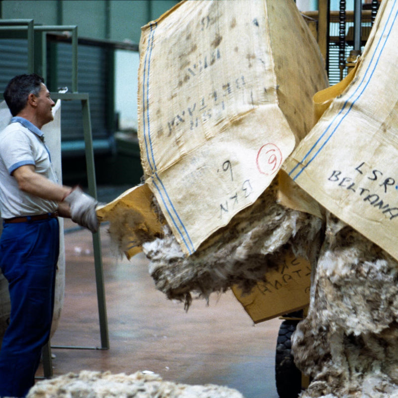 Forklift driver and employee un-baling the wool at Pettinatura di Verrone.
