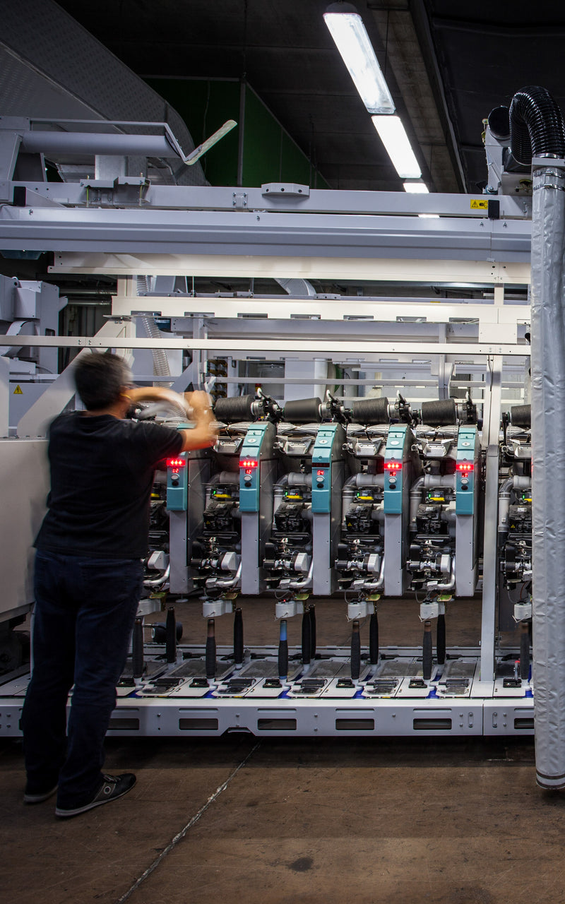 Production line of Merino wool coning machines at facility in Valle Mosso