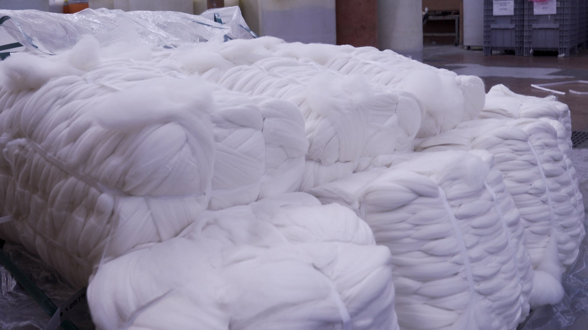 Combed Merino wool bump tops stacked in wharehouse