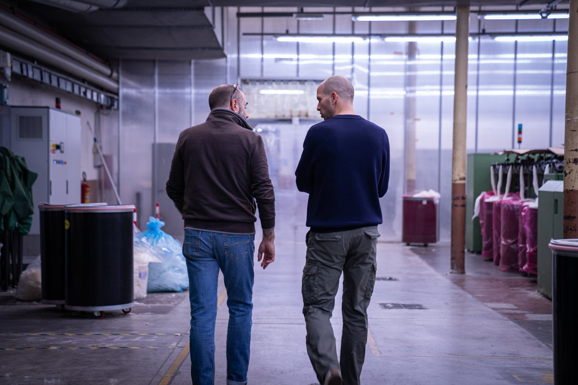 Founder of unborn walking through production hall with Tarcento facility manager