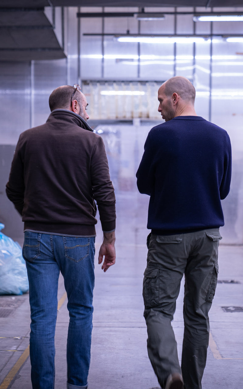 Founder of unborn walking through production hall with Tarcento facility manager