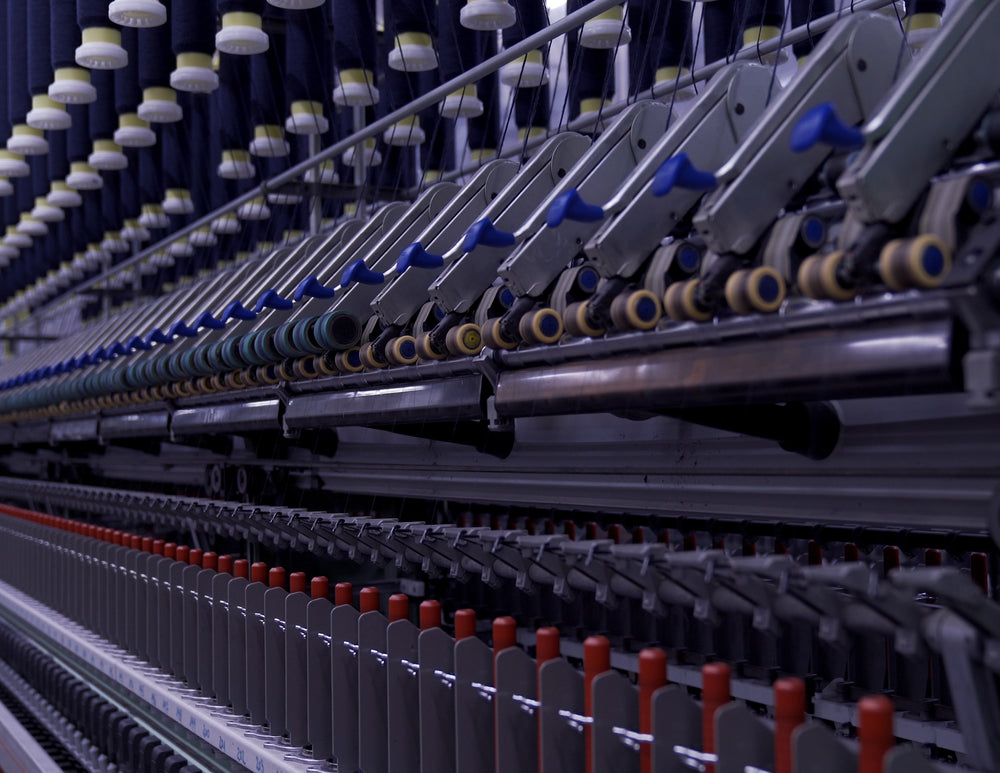Line of yarn spinning machines at spinning facility in Tarcento