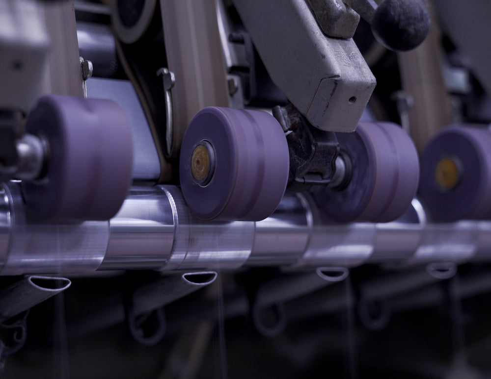 Closeup of yarn spinning machine at spinning facility in Tarcento