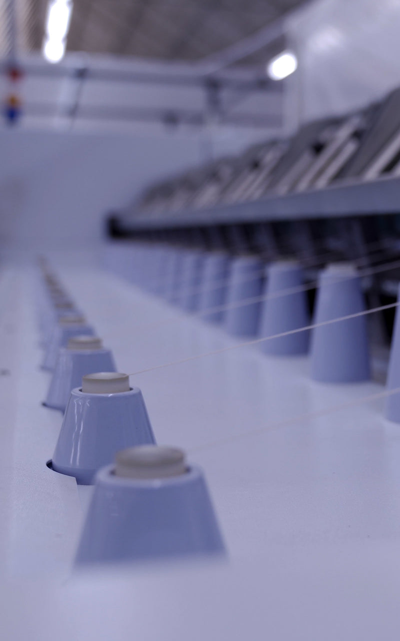 Closeup of yarn spinning machine at spinning facility in Tarcento