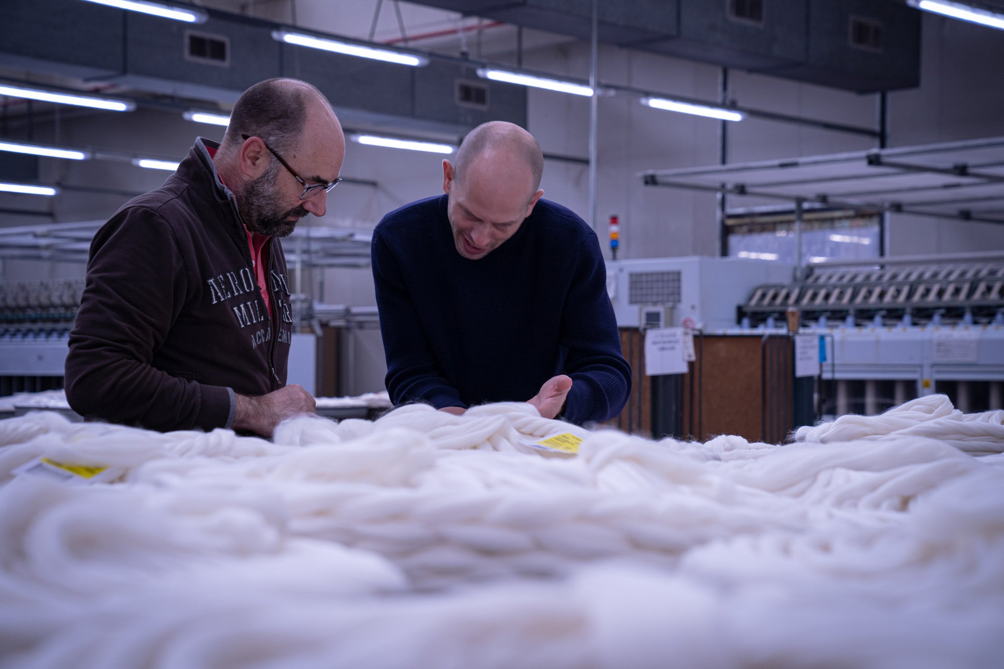 Inspection of combed Merino wool tops at spinning facility in Tarcento