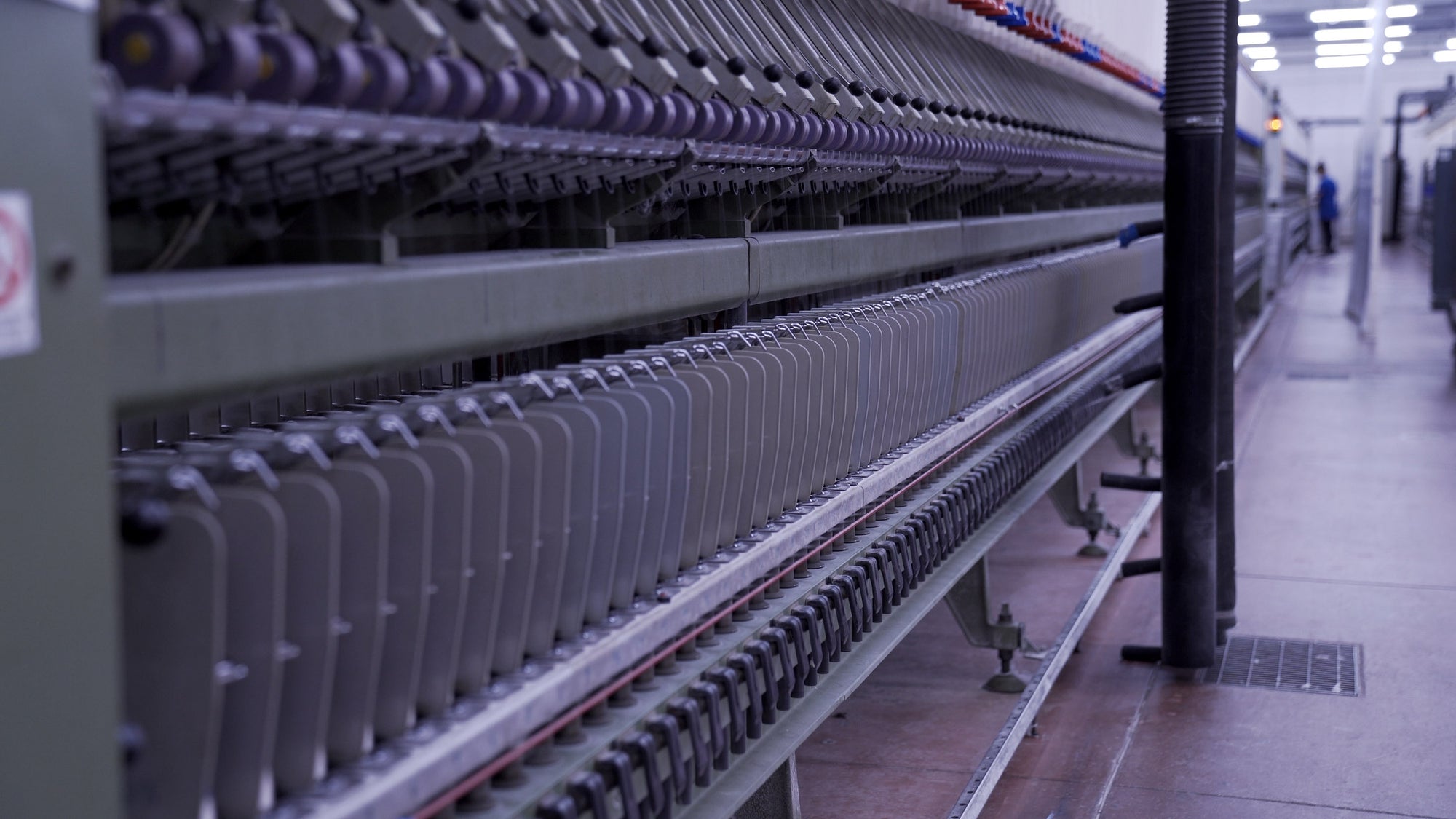 Line of yarn spinning machines at spinning facility in Tarcento