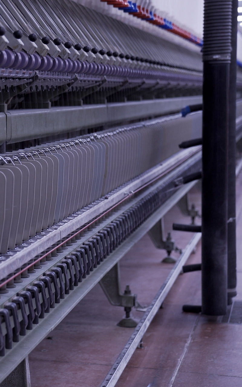 Line of yarn spinning machines at spinning facility in Tarcento