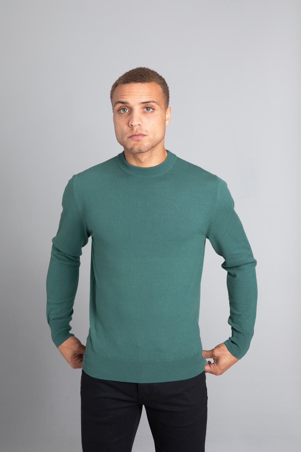 Model wearing The Merino Wool Sweater Light Foggy Green , front - Unborn