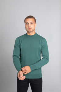 Model wearing The Merino Wool Sweater Light Foggy Green , front - Unborn