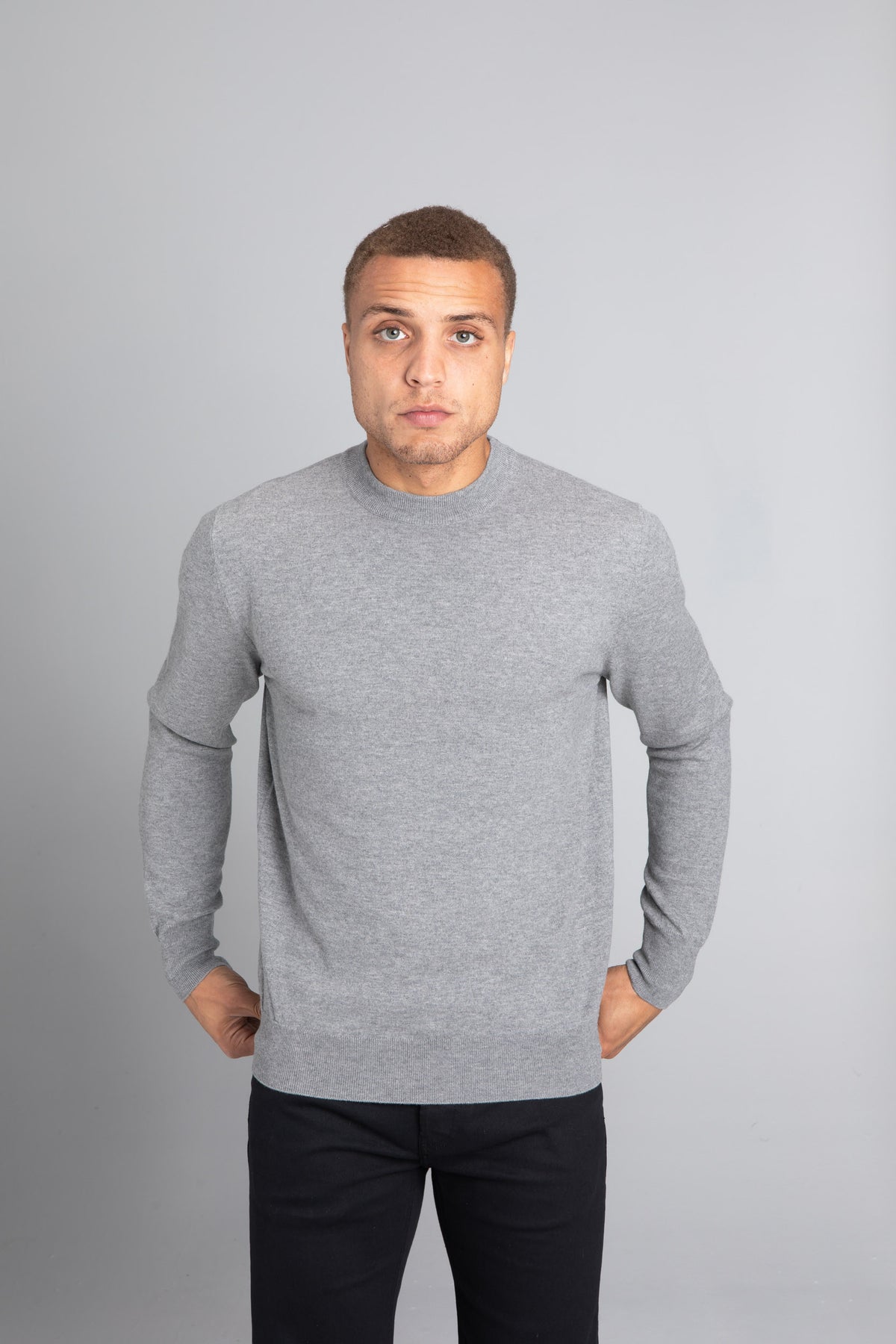 Model wearing The Merino Wool Sweater Light Grey Melange , front - Unborn