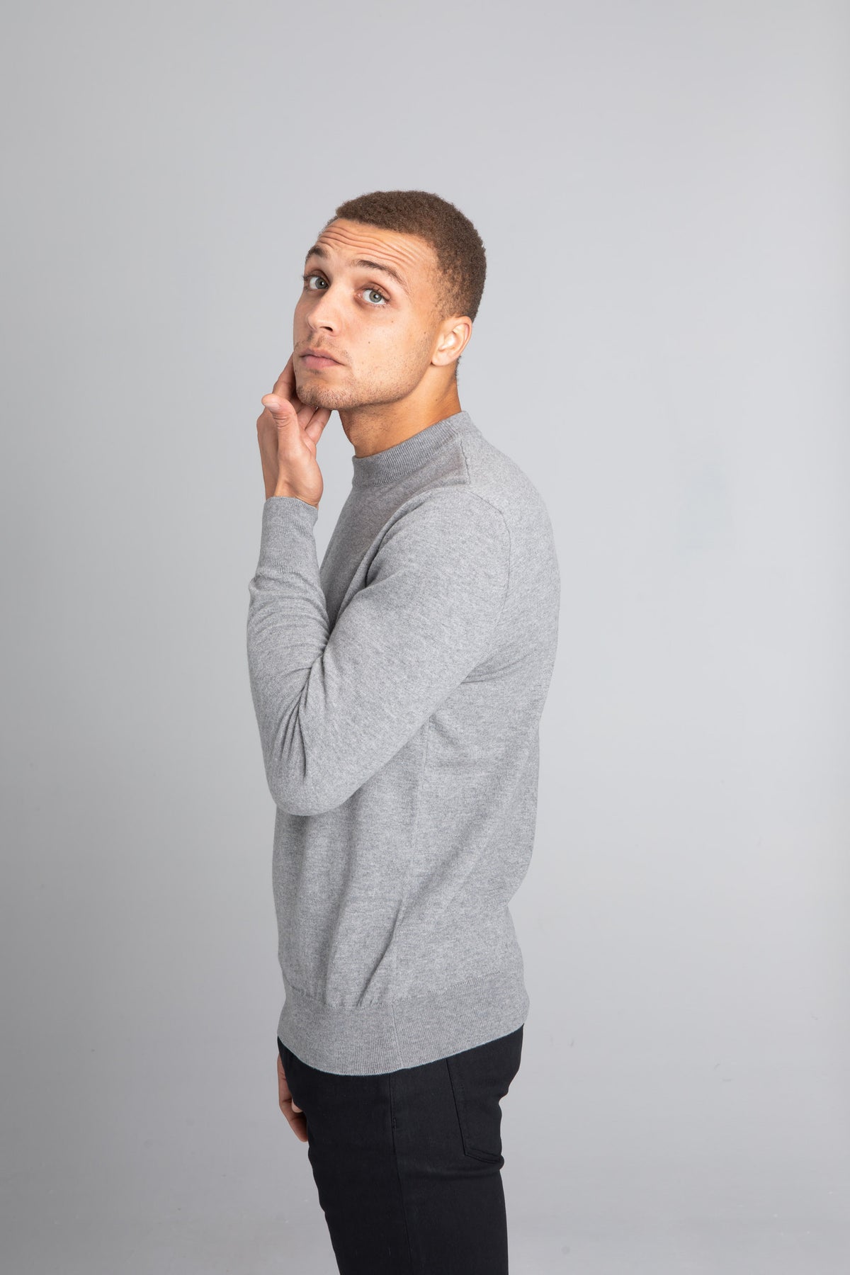 Model wearing The Merino Wool Sweater Light Grey Melange , left - Unborn