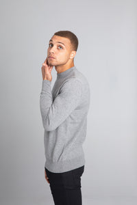 Model wearing The Merino Wool Sweater Light Grey Melange , left - Unborn