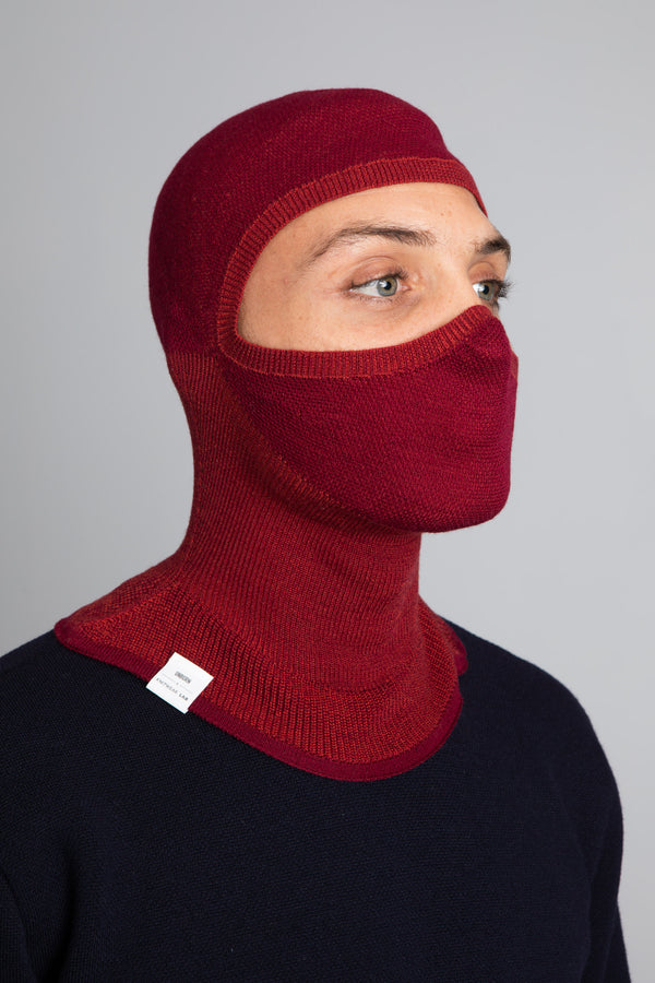 Model wearing The Merino Balaclava Brick Red from Unborn