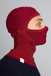 Model wearing The Merino Balaclava Brick Red
