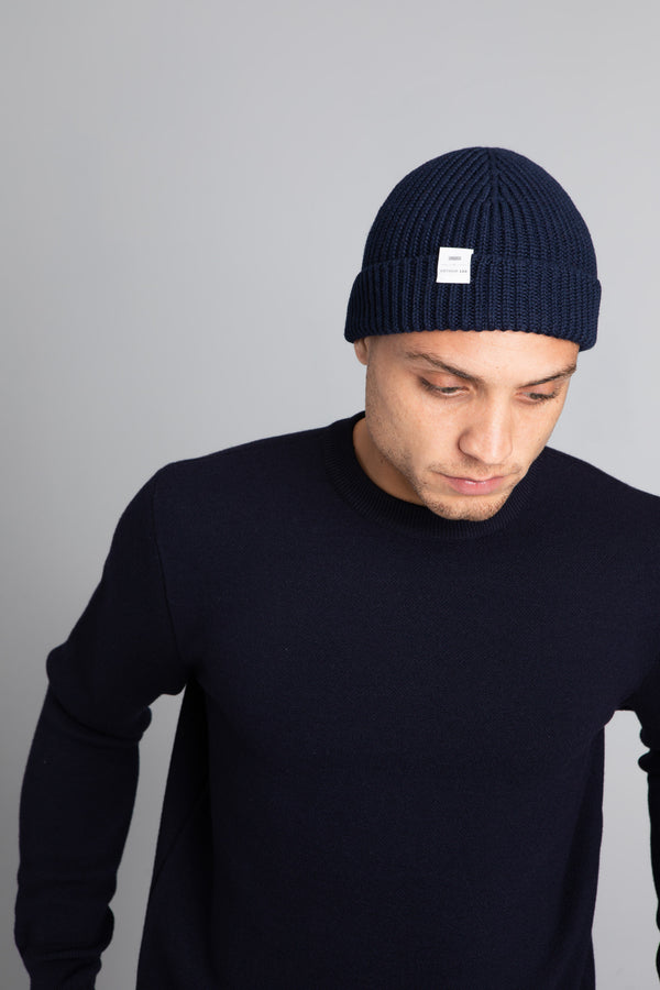 Model wearing The Merino wool beanie  imperial blue, front view Unborn
