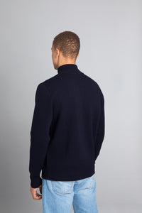 Model wearing the Merino wool Jacquard Button Up navy, back view Unborn