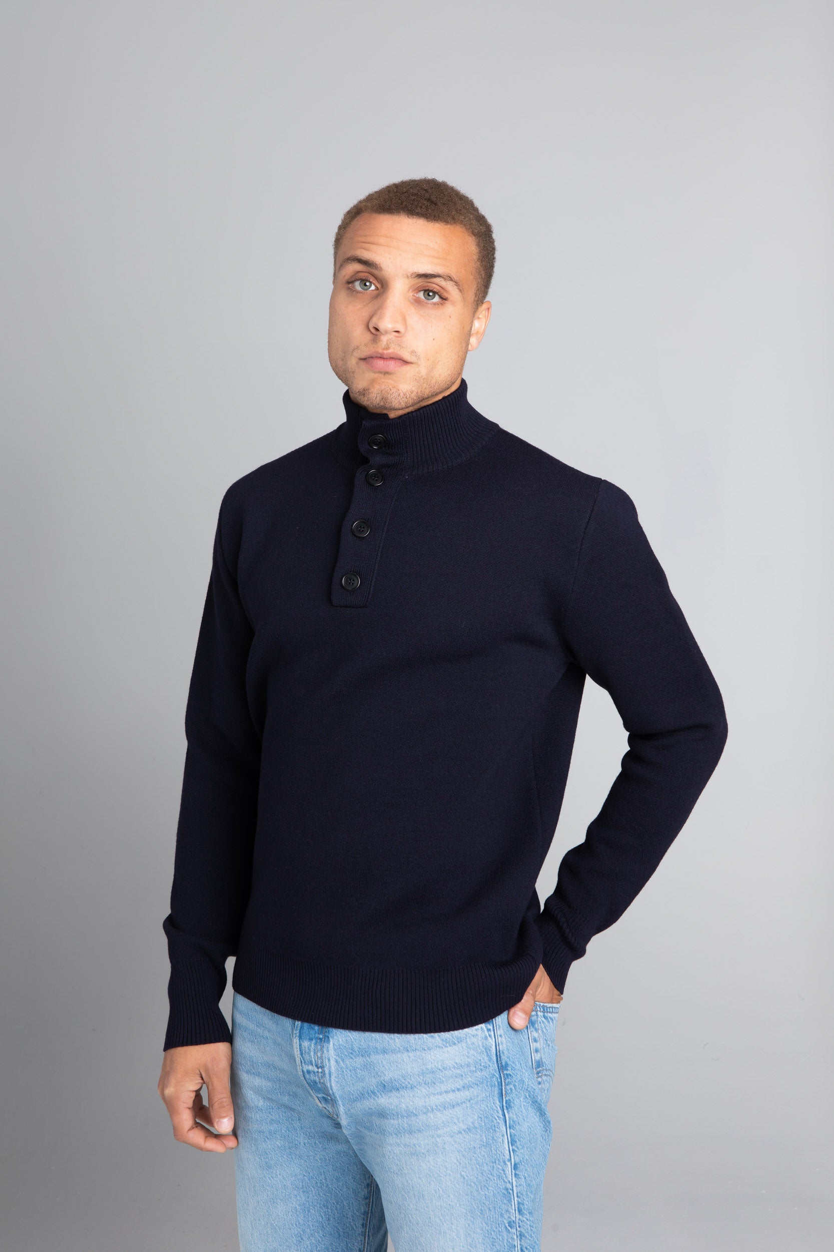 Model wearing the Merino wool Jacquard Button Up navy, front view Unborn