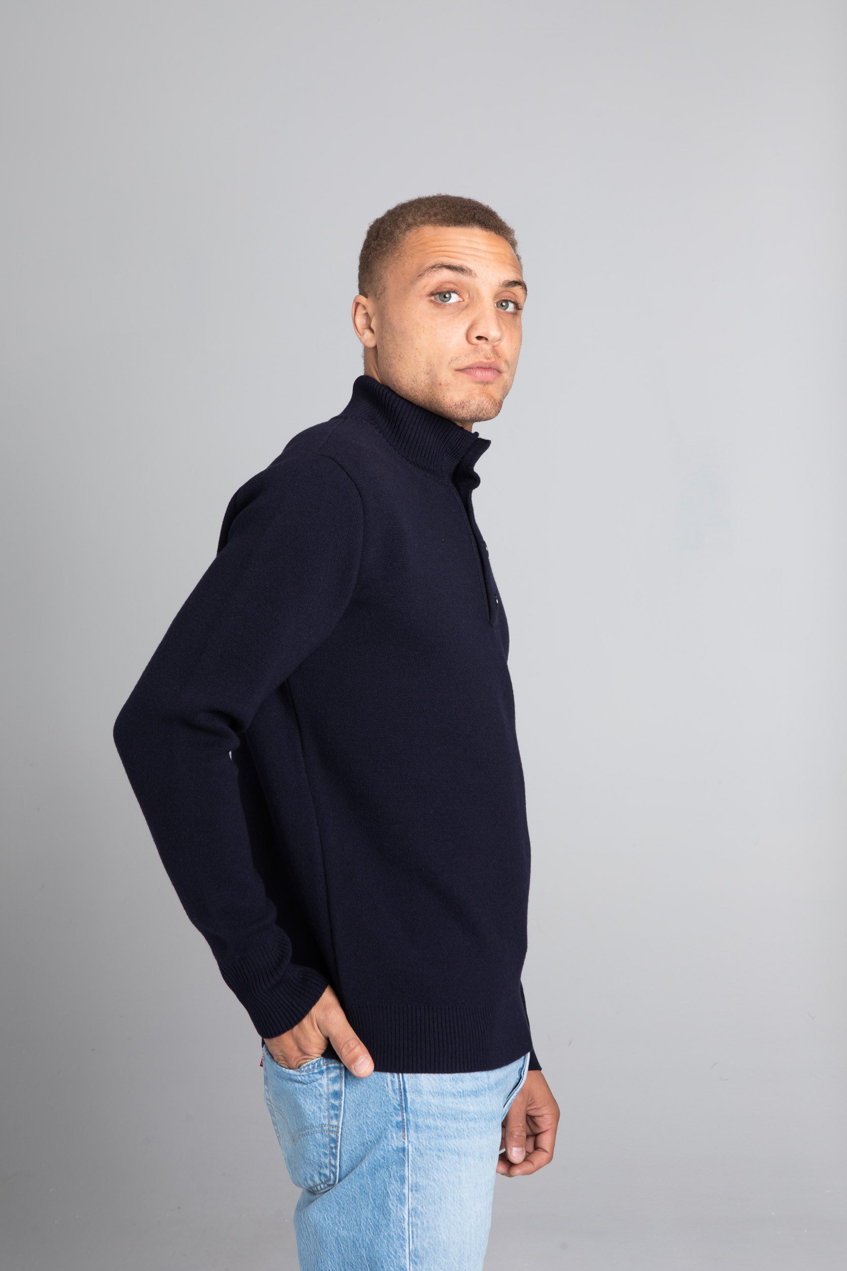 Model wearing the Merino wool Jacquard Button Up navy, right view Unborn