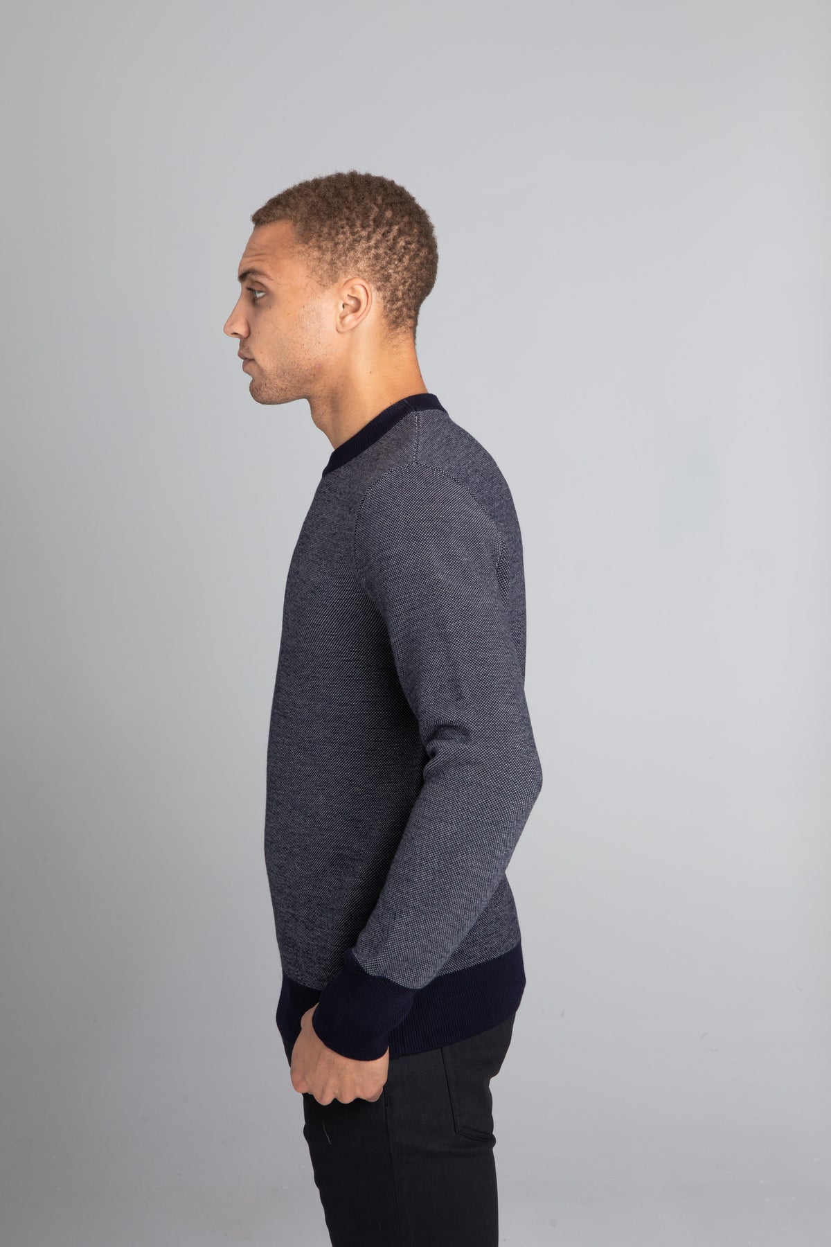 Model Wearing The Merino wool jaquard sweater Navy Grey, left - Unborn