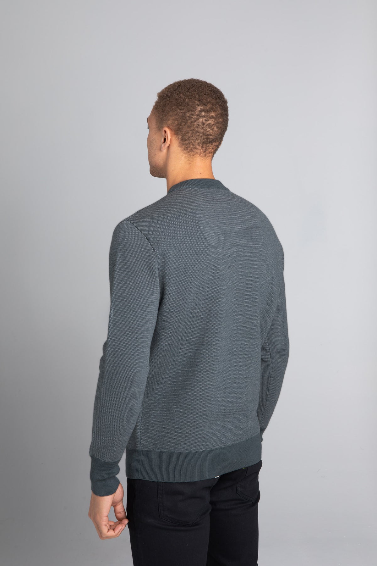 Model Wearing The Merino wool jaquard sweater Navy Grey, back - Unborn