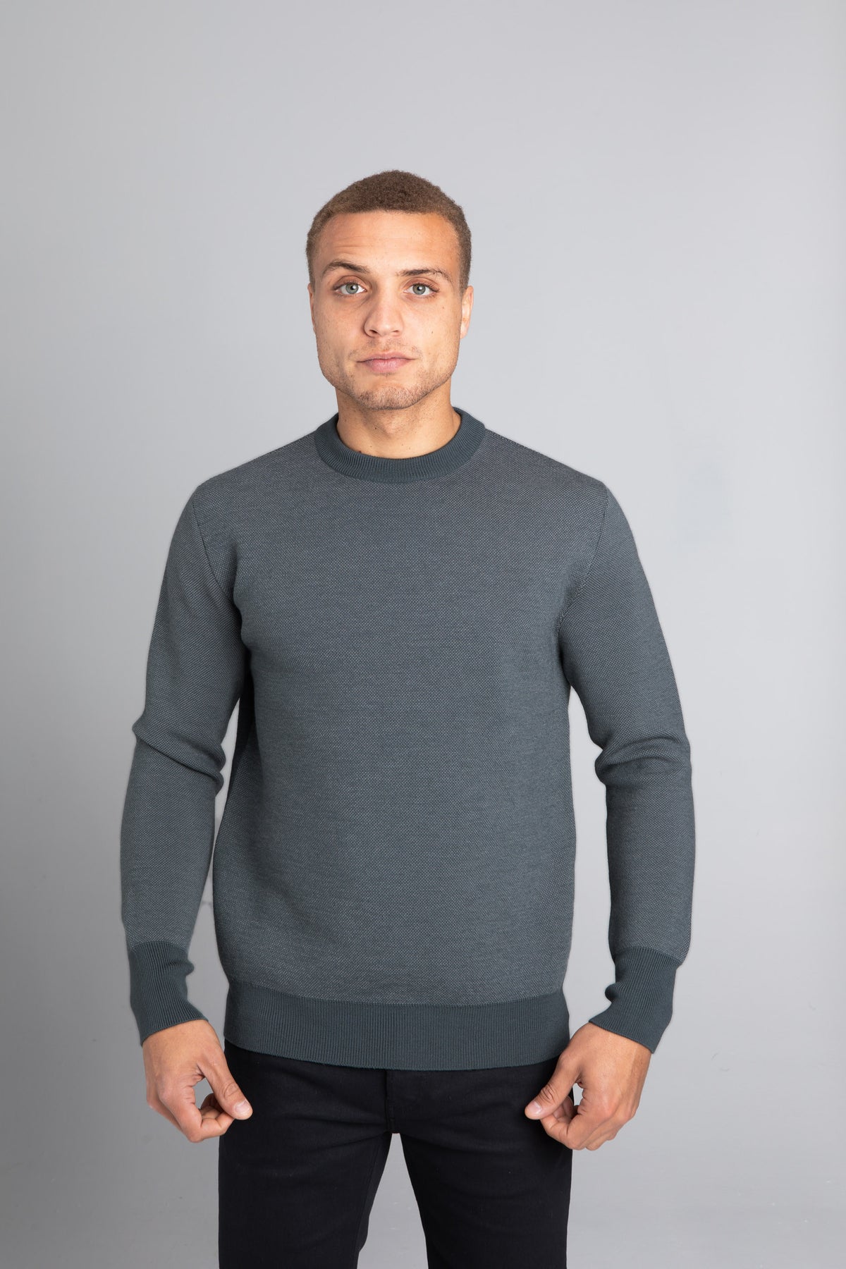 Model Wearing The Merino wool jaquard sweater Navy Grey, front - Unborn