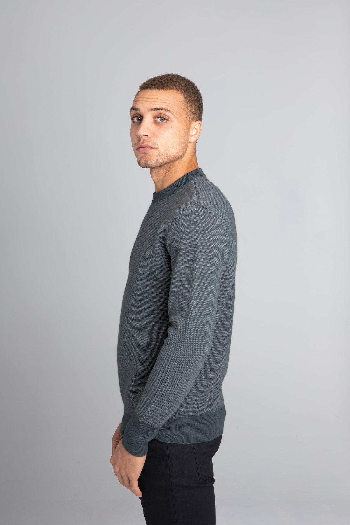 Model Wearing The Merino wool jaquard sweater Navy Grey, left - Unborn