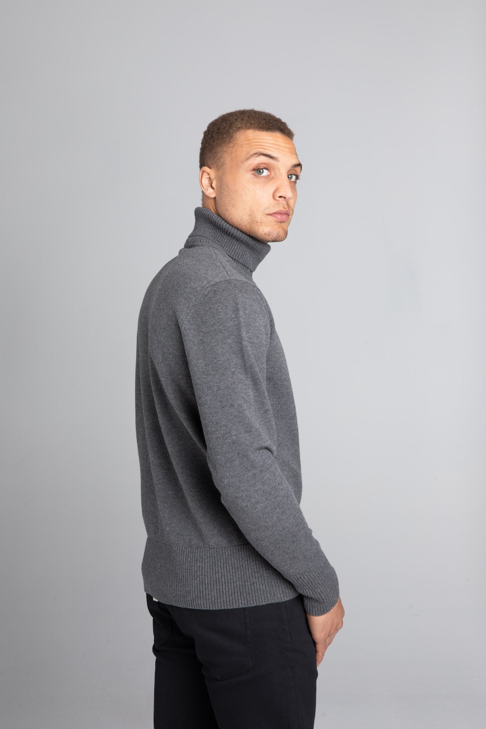 Model Wearing The Merino Wool Roll Neck Grey, back - Unborn