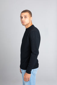 Model wearing The Merino Wool Sweater Black, left  - Unborn