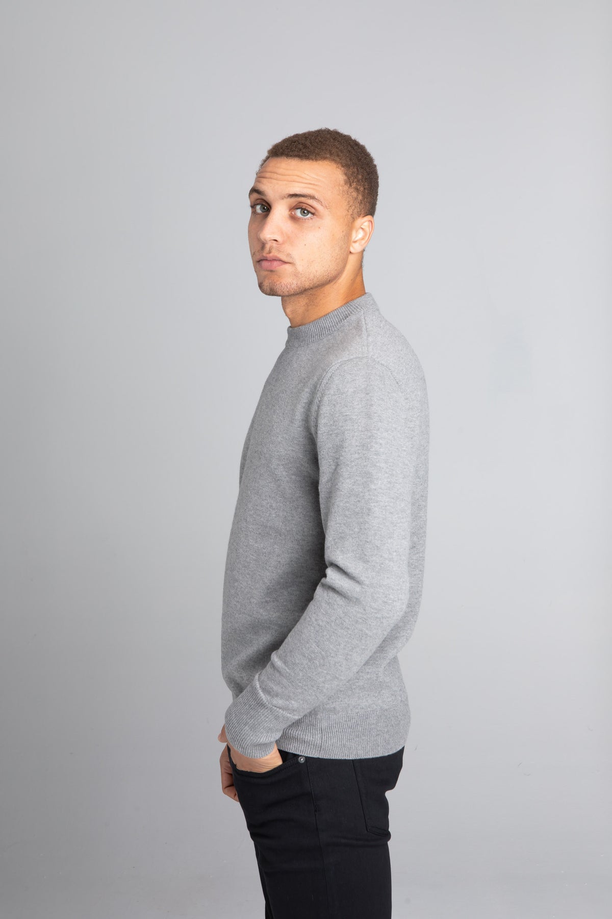 Model wearing The Merino Wool Sweater Grey Melange, left - Unborn