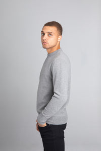 Model wearing The Merino Wool Sweater Grey Melange, left - Unborn