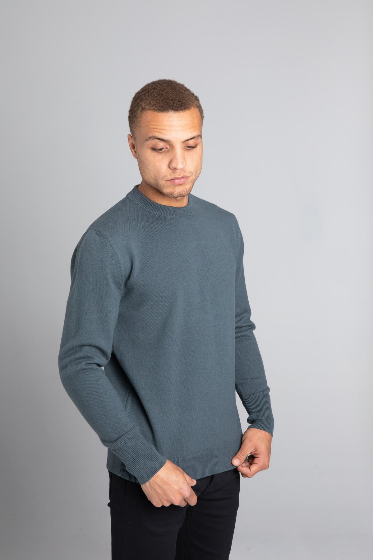 Model wearing The Merino Wool Sweater Olive Green, front - Unborn