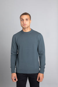 Model wearing The Merino Wool Sweater Olive Green, front - Unborn
