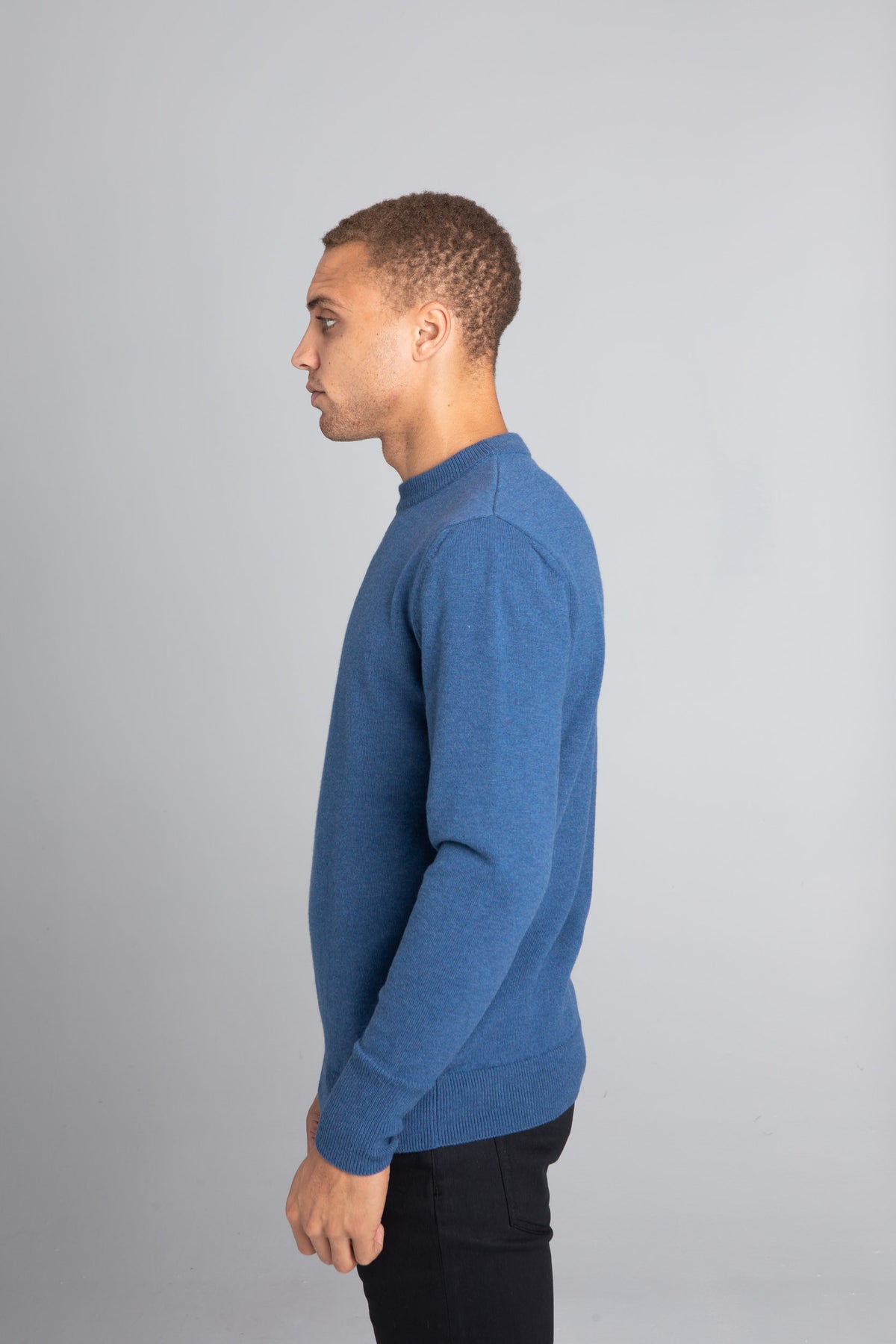 Model wearing The Merino Wool Sweater Sky Blue, left - Unborn